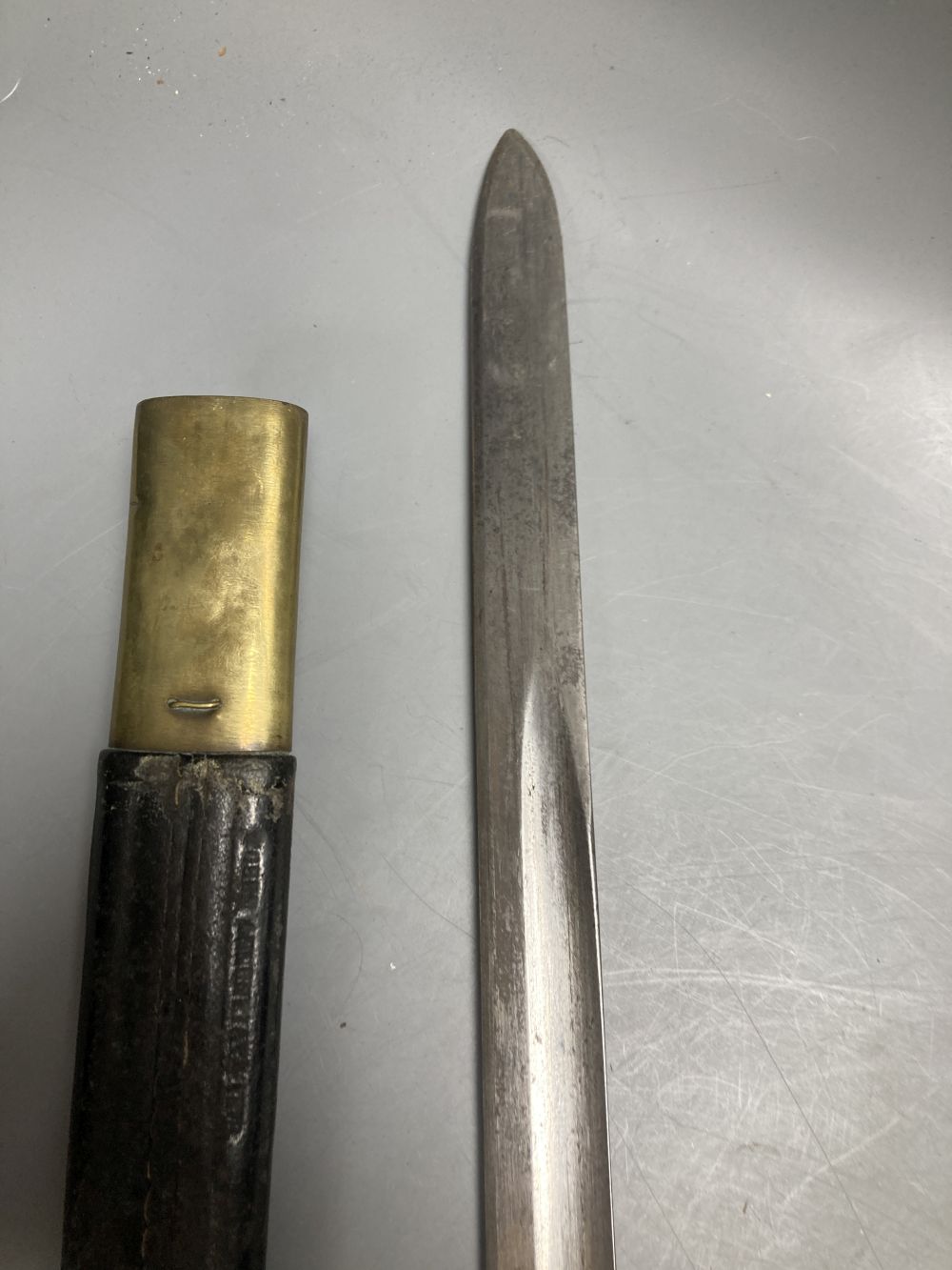 An Italian Torre Annunziata bayonet, 51cm blade, within leather and brass scabbard
